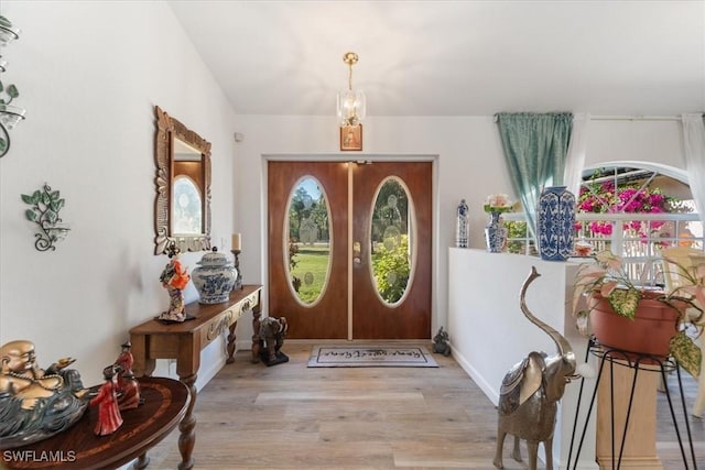 entrance foyer with french doors and light wood-type flooring