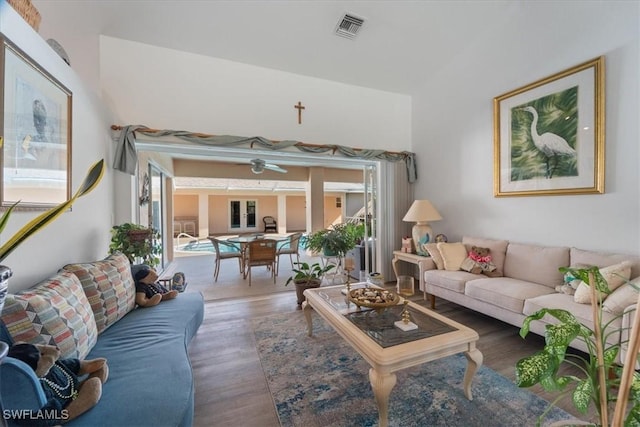 living room with hardwood / wood-style flooring and ceiling fan