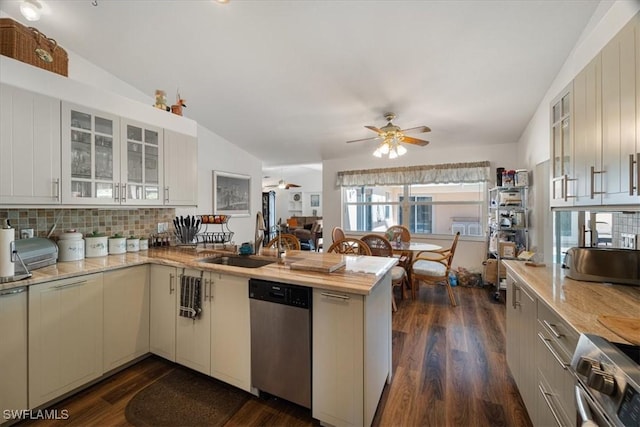 kitchen featuring dishwasher, sink, tasteful backsplash, dark hardwood / wood-style flooring, and lofted ceiling