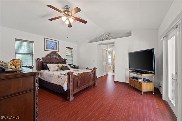 bedroom with dark hardwood / wood-style flooring, vaulted ceiling, and ceiling fan