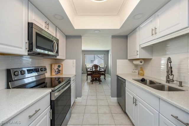 kitchen with white cabinetry, appliances with stainless steel finishes, and a sink