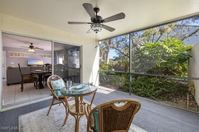 sunroom featuring ceiling fan