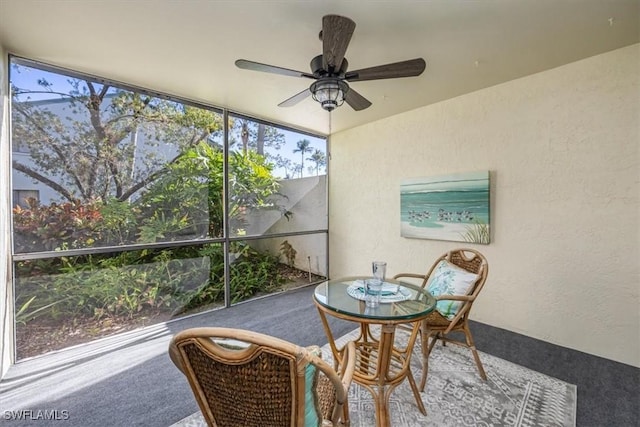 sunroom featuring ceiling fan