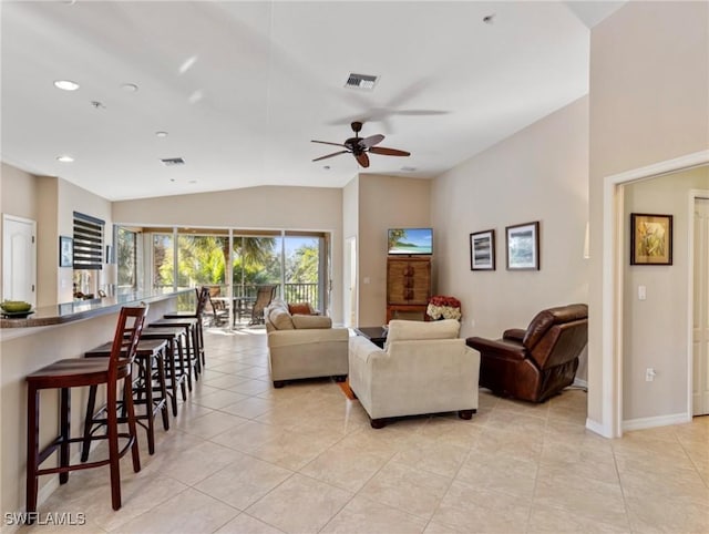 tiled living room featuring ceiling fan and vaulted ceiling