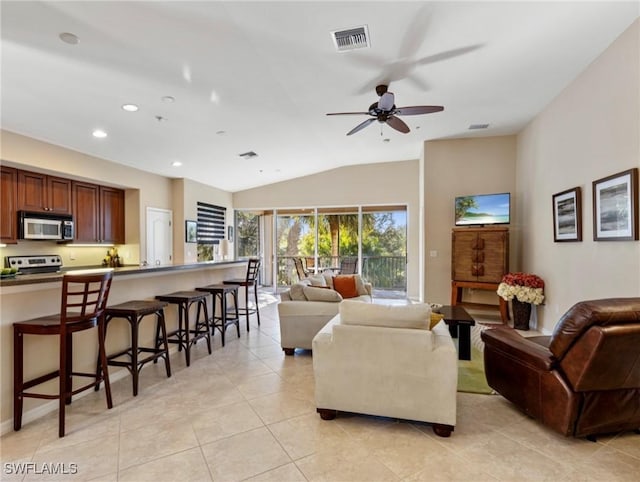 living room featuring ceiling fan, light tile patterned flooring, and lofted ceiling