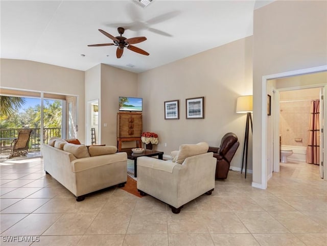 tiled living room featuring ceiling fan and vaulted ceiling