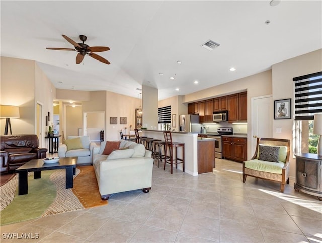 living room featuring ceiling fan and light tile patterned floors