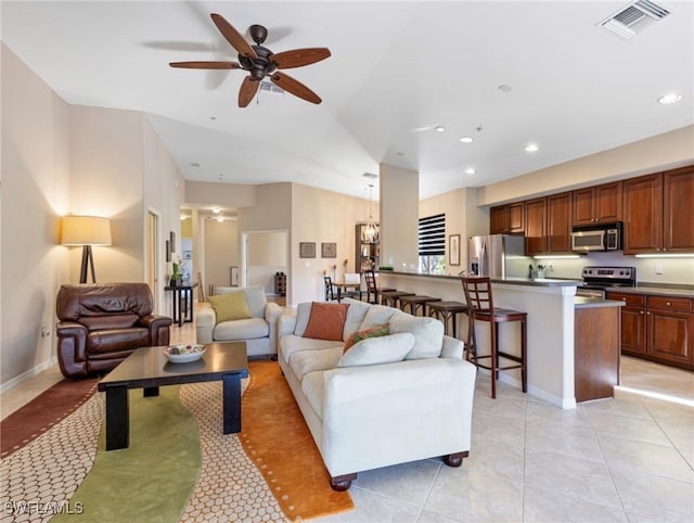 living room featuring ceiling fan and light tile patterned floors