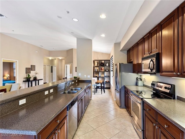 kitchen featuring light tile patterned floors, stainless steel appliances, vaulted ceiling, and sink