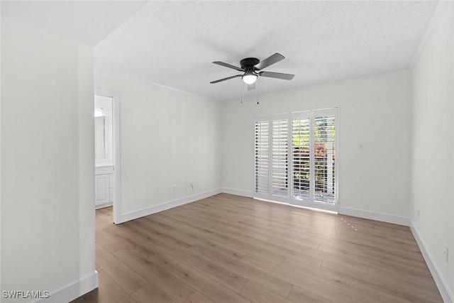 empty room featuring a textured ceiling, hardwood / wood-style flooring, and ceiling fan