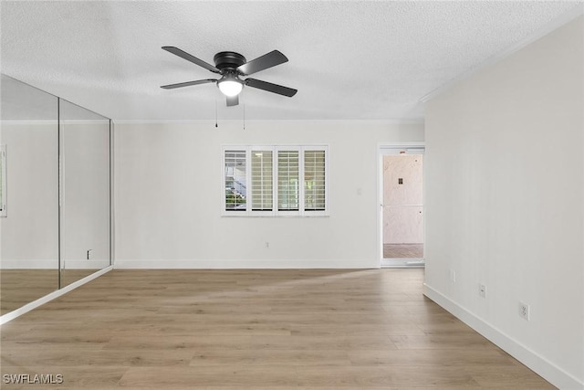 interior space with a closet, ceiling fan, light hardwood / wood-style flooring, and a textured ceiling