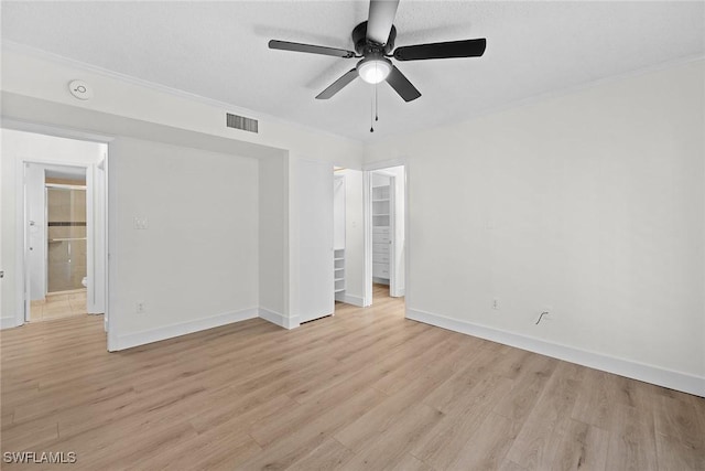 unfurnished room with ceiling fan, light hardwood / wood-style floors, and a textured ceiling