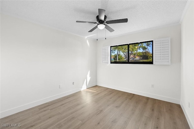 empty room with a textured ceiling, light hardwood / wood-style flooring, ceiling fan, and crown molding