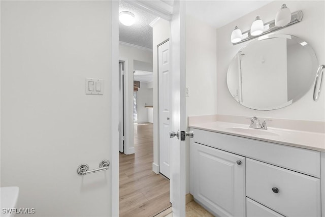 bathroom with vanity, wood-type flooring, and a textured ceiling