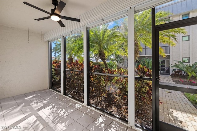 unfurnished sunroom featuring a wealth of natural light and ceiling fan