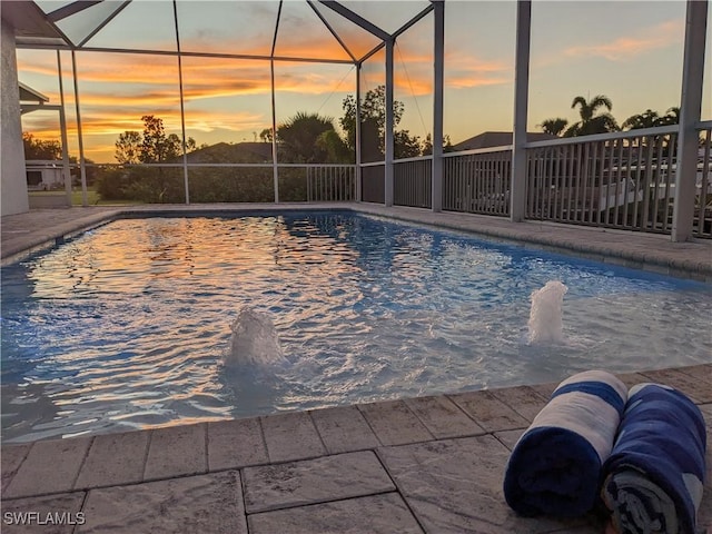 view of pool at dusk