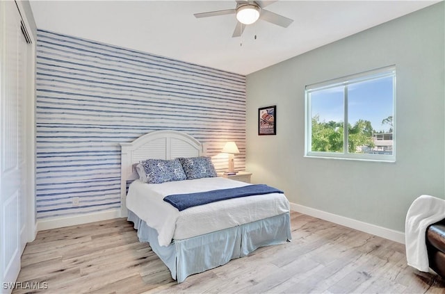 bedroom featuring light hardwood / wood-style floors and ceiling fan