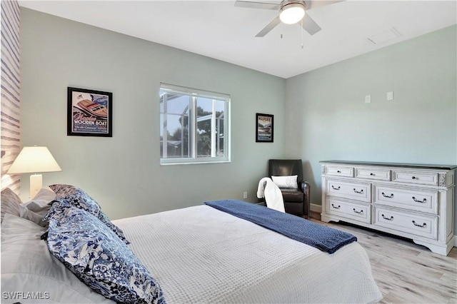 bedroom with ceiling fan and light hardwood / wood-style flooring