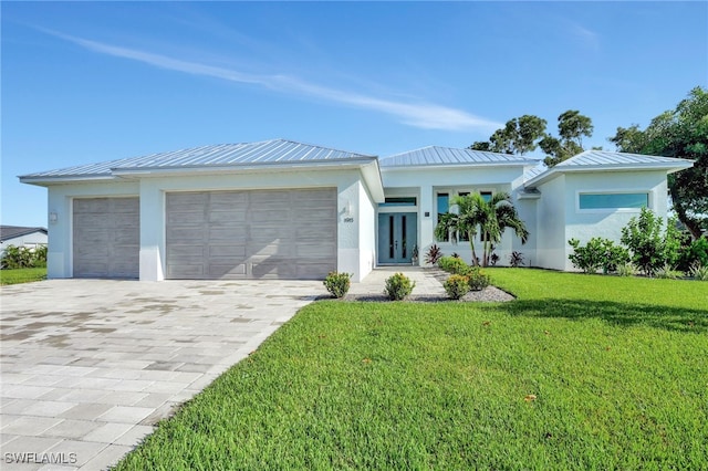 view of front of home featuring a front lawn and a garage