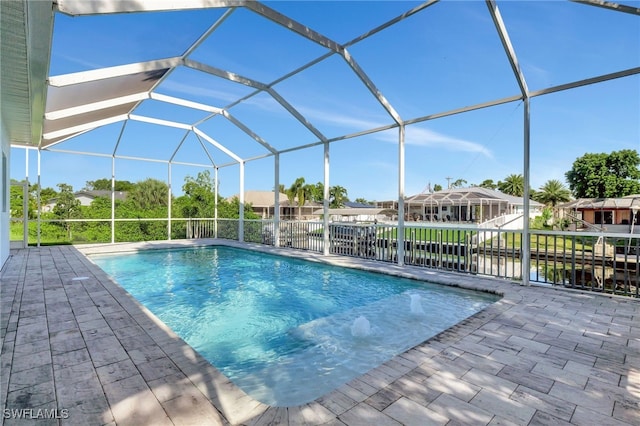 view of swimming pool with glass enclosure, pool water feature, and a patio