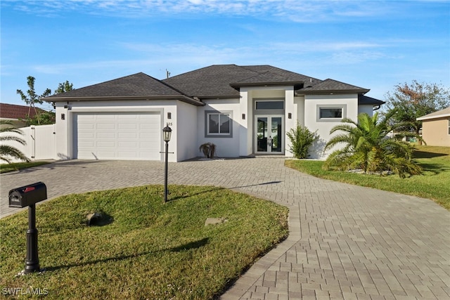 view of front of property featuring french doors and a garage