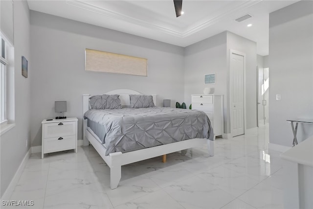 bedroom with ceiling fan, crown molding, and a closet