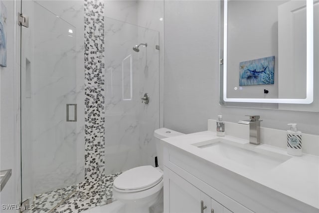 bathroom featuring vanity, an enclosed shower, and toilet