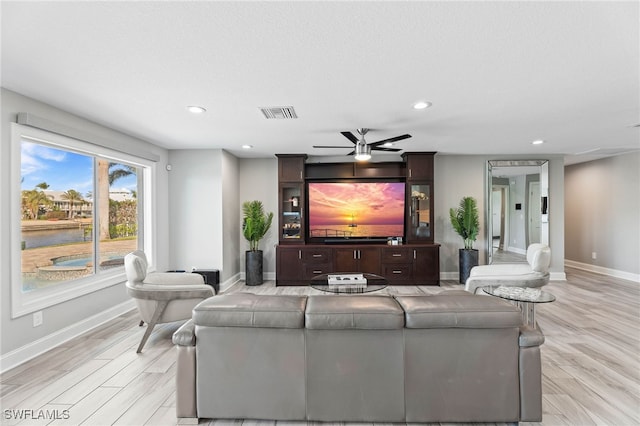 living area featuring ceiling fan, light wood-type flooring, visible vents, recessed lighting, and baseboards