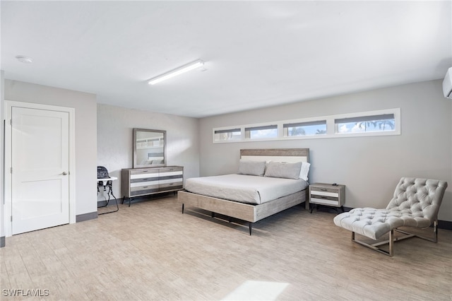 bedroom featuring wood finished floors and baseboards