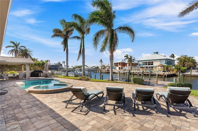 view of swimming pool featuring a patio, a dock, a pool with connected hot tub, and a water view