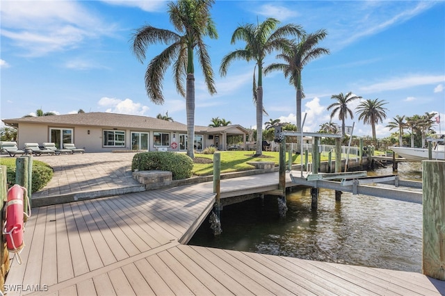 dock area with a patio area and a water view