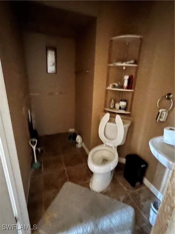 bathroom with tile patterned flooring and toilet