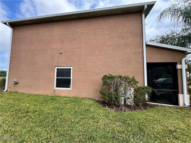 view of side of property with a yard