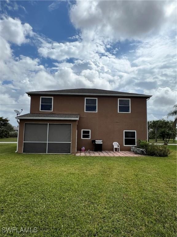 rear view of property featuring a patio area and a lawn