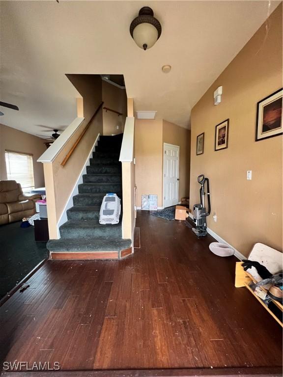 foyer entrance featuring ceiling fan, lofted ceiling, and hardwood / wood-style flooring