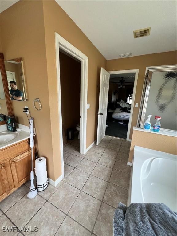 full bathroom with tile patterned floors, vanity, separate shower and tub, and toilet