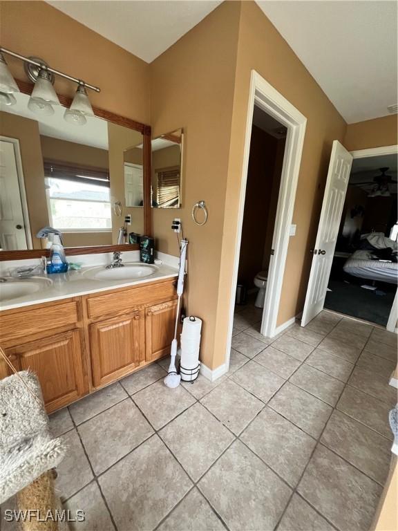 bathroom featuring tile patterned floors, vanity, and toilet