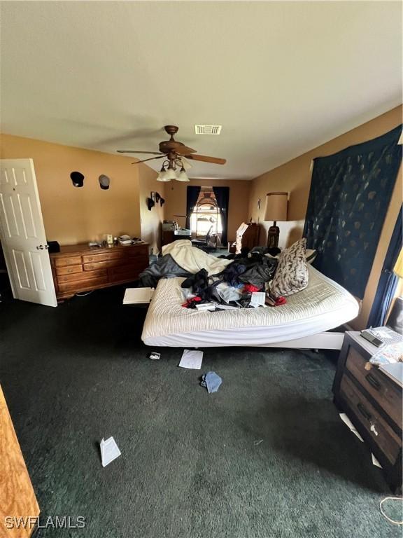 bedroom with dark carpet and ceiling fan