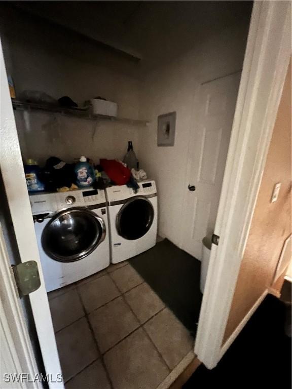 clothes washing area featuring tile patterned floors and independent washer and dryer