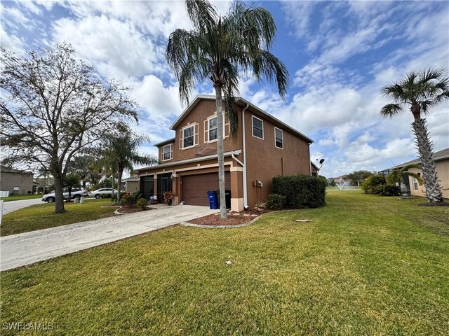 view of side of property with a yard and a garage