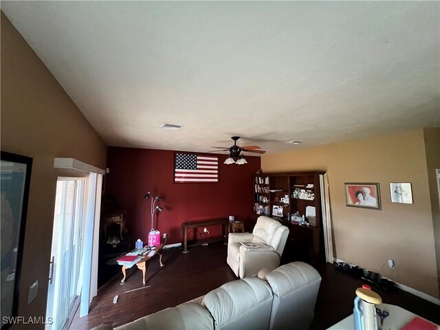 living room with dark hardwood / wood-style floors and ceiling fan