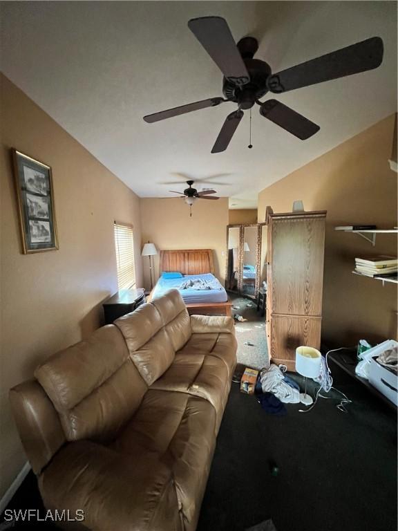 living room with ceiling fan and lofted ceiling