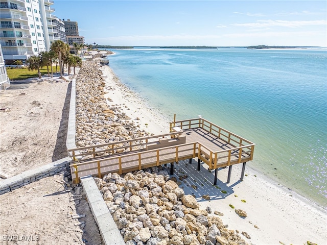 view of property's community with a beach view and a water view