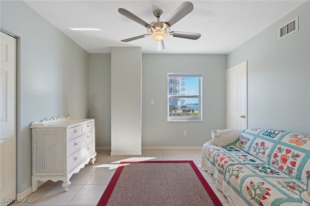 tiled bedroom featuring ceiling fan