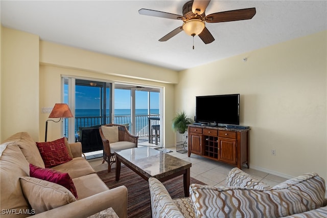 living room featuring light tile patterned floors and ceiling fan