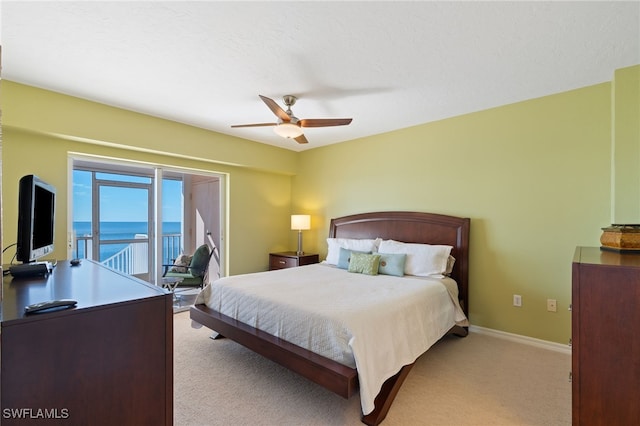 bedroom with ceiling fan, access to exterior, and light colored carpet