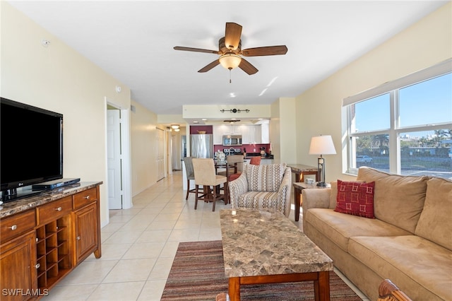 living room with ceiling fan and light tile patterned floors