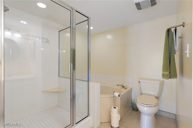 bathroom featuring tile patterned flooring, toilet, and independent shower and bath