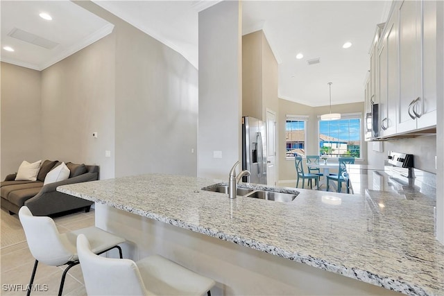 kitchen with white cabinets, light stone counters, sink, and stainless steel appliances