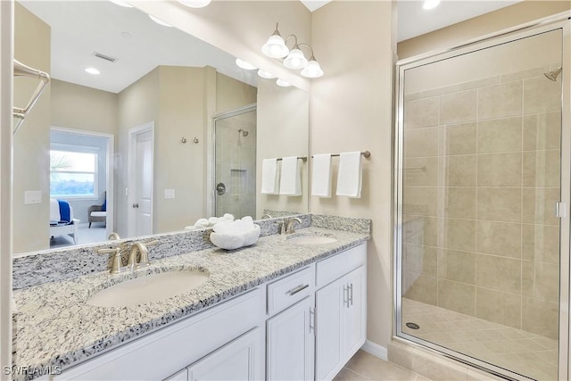 bathroom featuring tile patterned flooring, vanity, and an enclosed shower